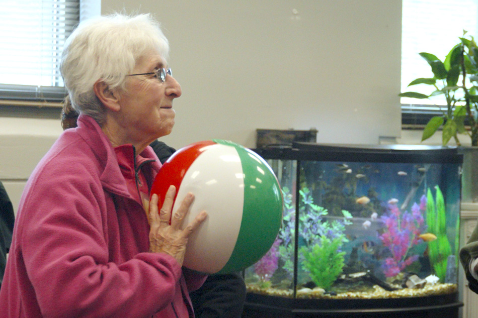 Senior woman getting ready to throw a multicolored ball